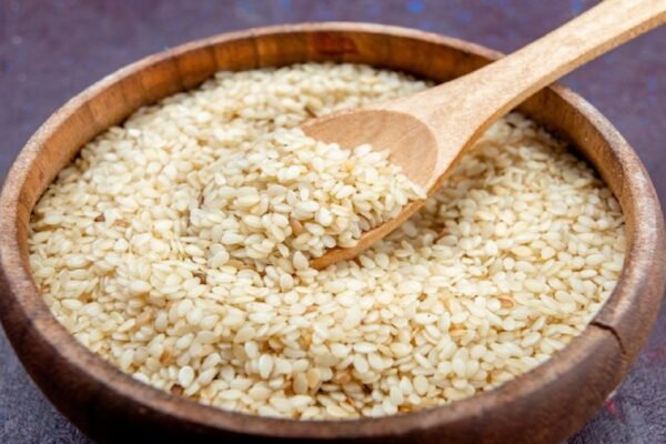 A landscape image of a bowl filled with magaj seeds and a plate of magaj burfi, highlighting traditional Indian flavors.